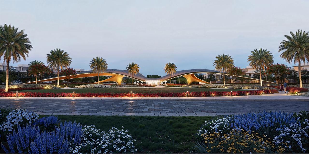 Azizi Florence Sharjah &mdash; the community gateway lit at dusk