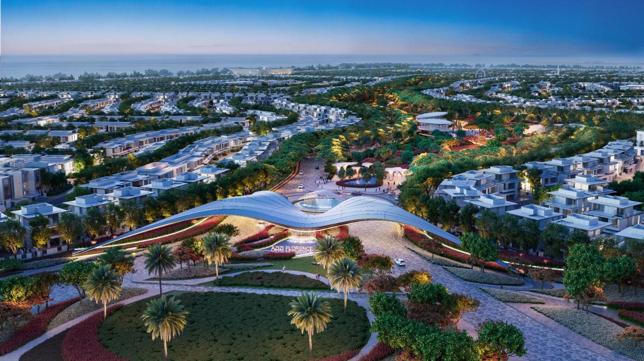 Azizi Florence Sharjah &mdash; the community gateway, central park and surrounding villa clusters at dusk